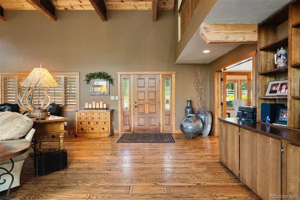 a view of a livingroom with furniture hardwood floor and windows