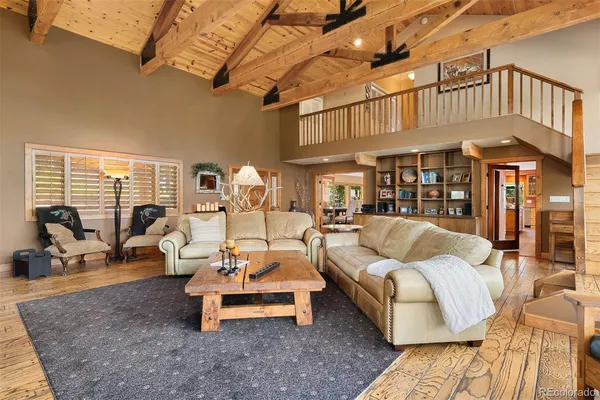 a living room with furniture a flat screen tv and a table