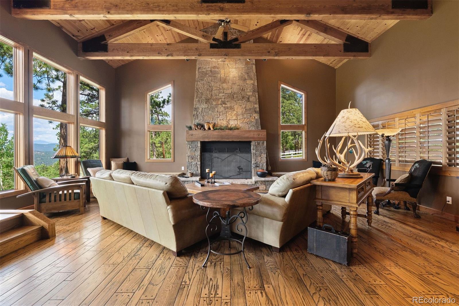 12351 South Ridge Road Conifer, CO 80433 - Photo 10 of 50 a living room with furniture and wooden floor