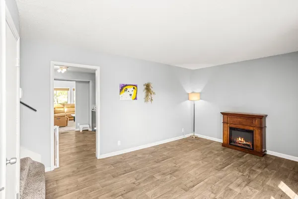a view of empty room with a fireplace