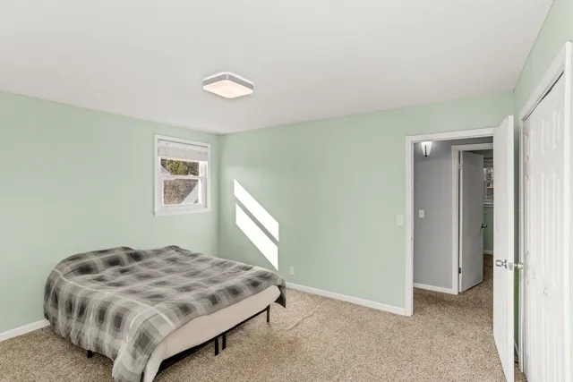 a bedroom with a bed and a window