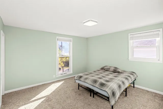 a bedroom with a bed and a window