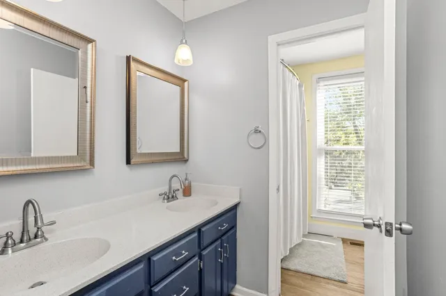 a bathroom with 2 sink and a mirror