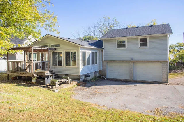 a front view of a house with a yard outdoor seating and garage