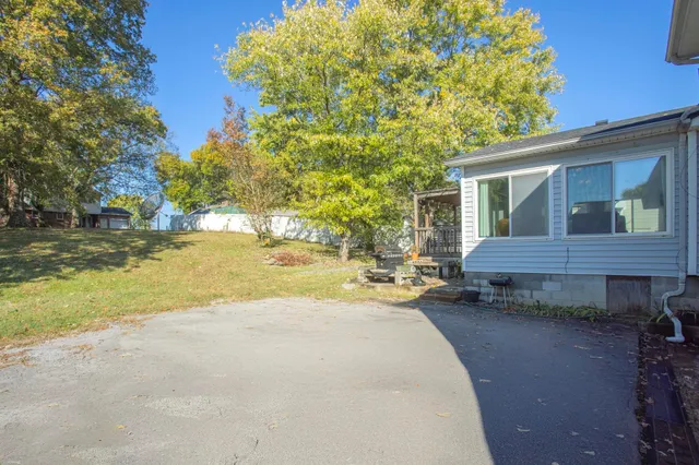 a view of a house with backyard and sitting area