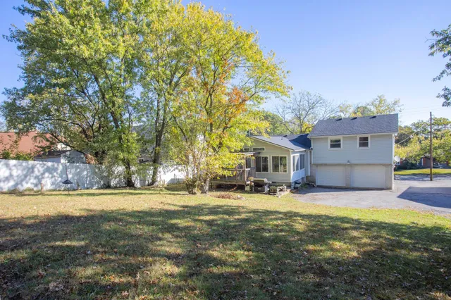 a view of a house with a yard and trees