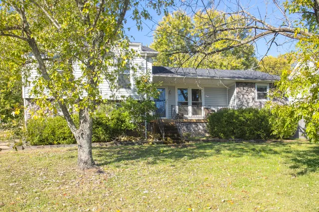 a view of house with yard