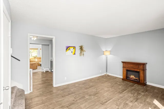 a view of empty room with a fireplace