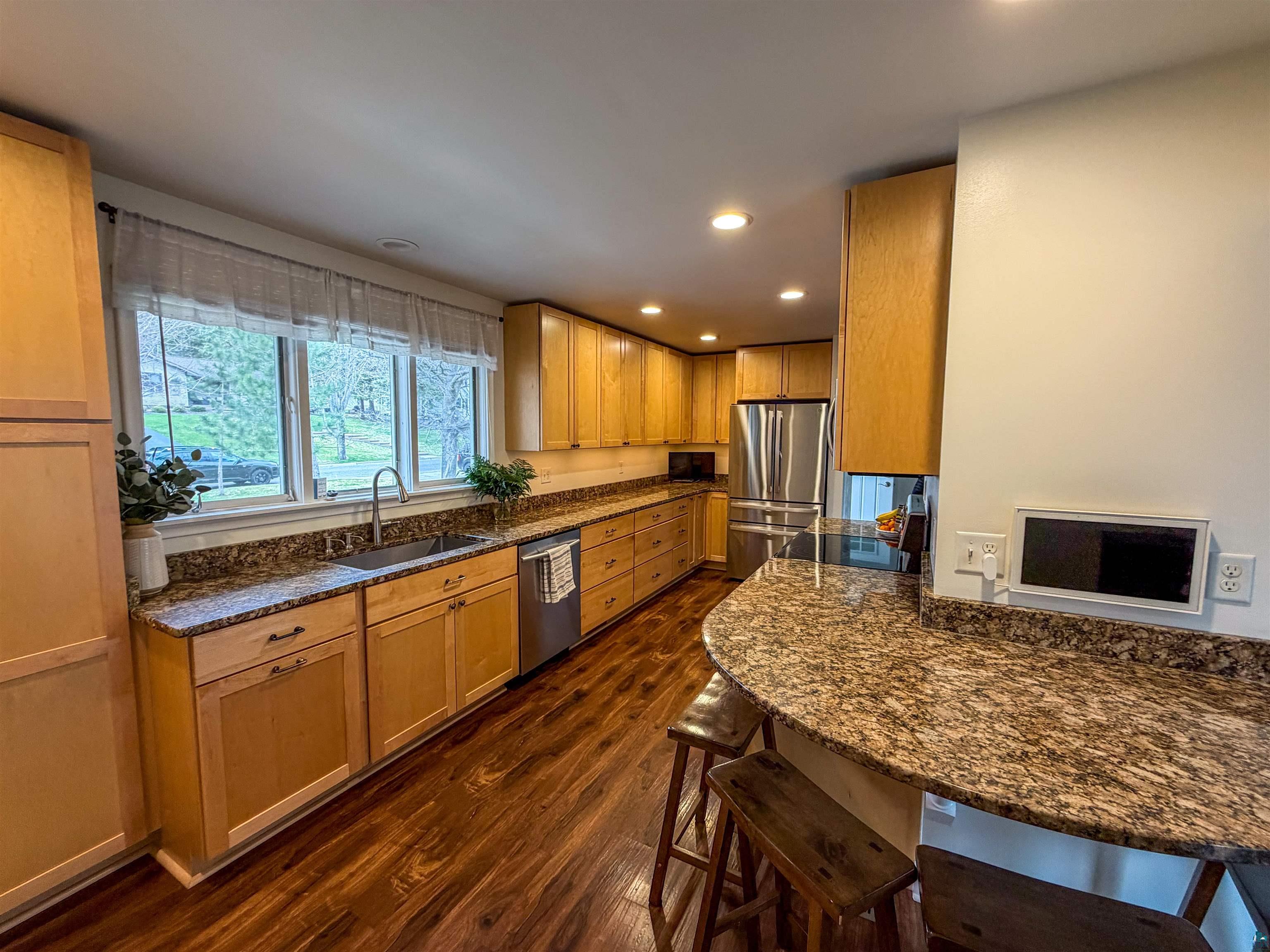 3704 Greysolon Road Duluth, MN 55804 - Photo 10 of 51 Kitchen featuring wood-finish flooring and ample cabinetry