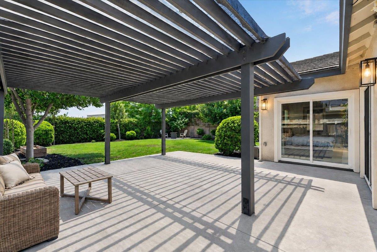 437 Silver Ridge Court Oakdale, CA 95361 - Photo 2 of 41 a view of a patio with table and chairs floor to ceiling window with wooden fence