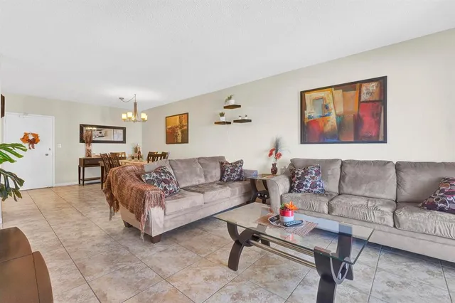 a living room with furniture and paintings on the wall