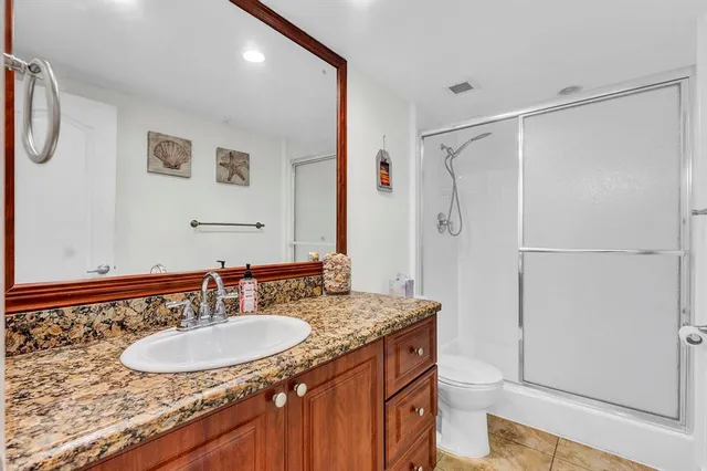 a bathroom with a sink toilet a mirror and shower