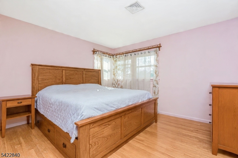 2142 South Branch Road Neshanic Station, NJ 08853 - Photo 16 of 48 a bed sitting in a bedroom next to a window