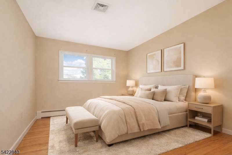 2142 South Branch Road Neshanic Station, NJ 08853 - Photo 17 of 48 a bedroom with a bed and wooden floor