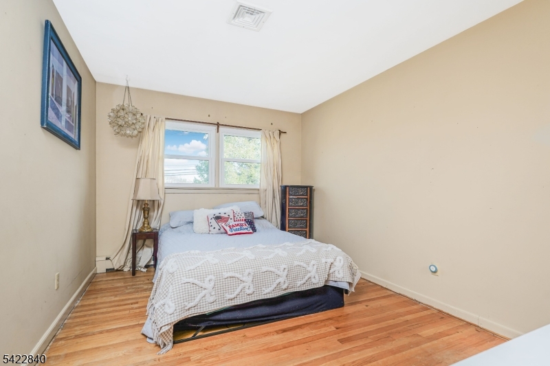 2142 South Branch Road Neshanic Station, NJ 08853 - Photo 18 of 48 a bedroom with a bed and wooden floor