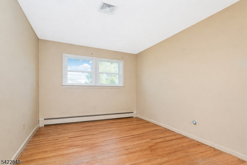 2142 South Branch Road Neshanic Station, NJ 08853 - Photo 39 of 48 an empty room with wooden floor and windows