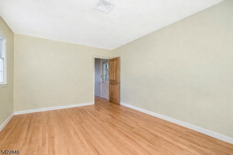 2142 South Branch Road Neshanic Station, NJ 08853 - Photo 40 of 48 a view of an empty room with wooden floor