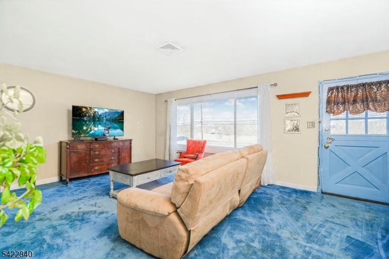 2142 South Branch Road Neshanic Station, NJ 08853 - Photo 5 of 48 a living room with furniture and a flat screen tv