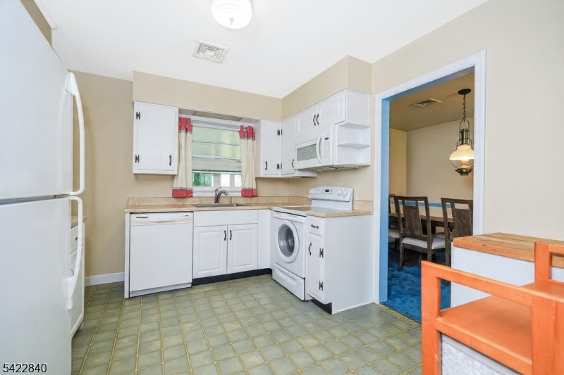 2142 South Branch Road Neshanic Station, NJ 08853 - Photo 7 of 48 a kitchen with white cabinets and white appliances