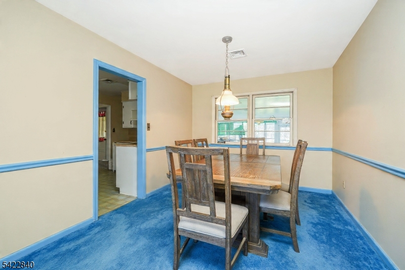 2142 South Branch Road Neshanic Station, NJ 08853 - Photo 10 of 48 a dining room with furniture a chandelier and wooden floor