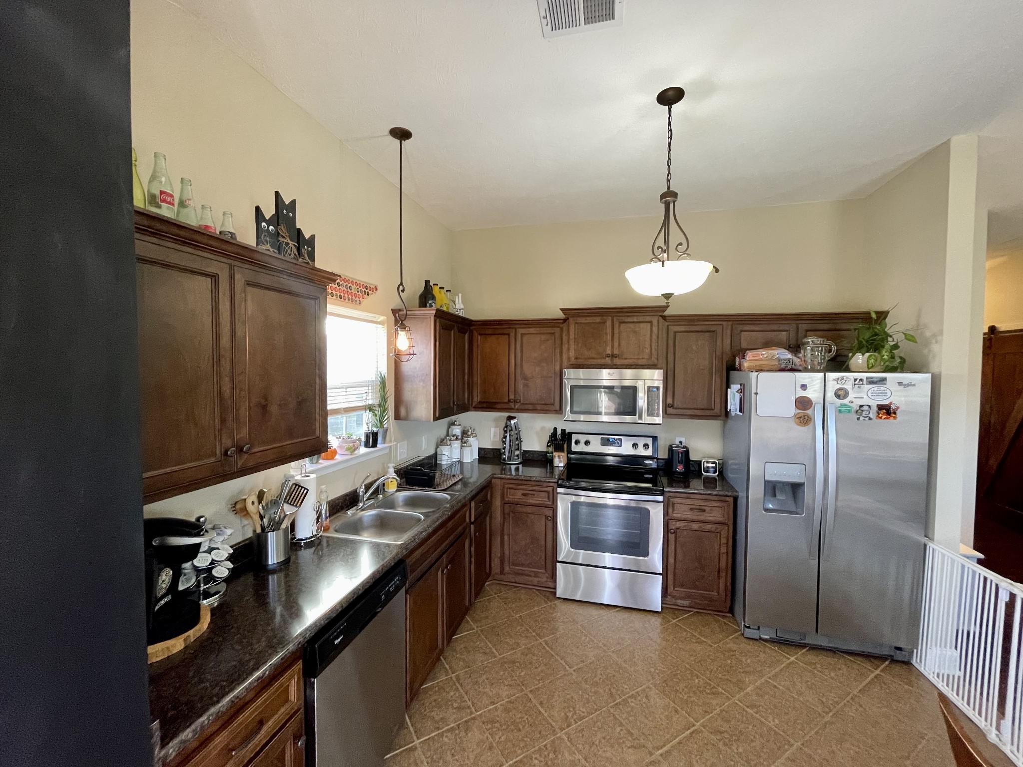 339 Golfview Lane Springfield, TN 37172 - Photo 11 of 34 a kitchen with stainless steel appliances granite countertop a sink a stove and a refrigerator