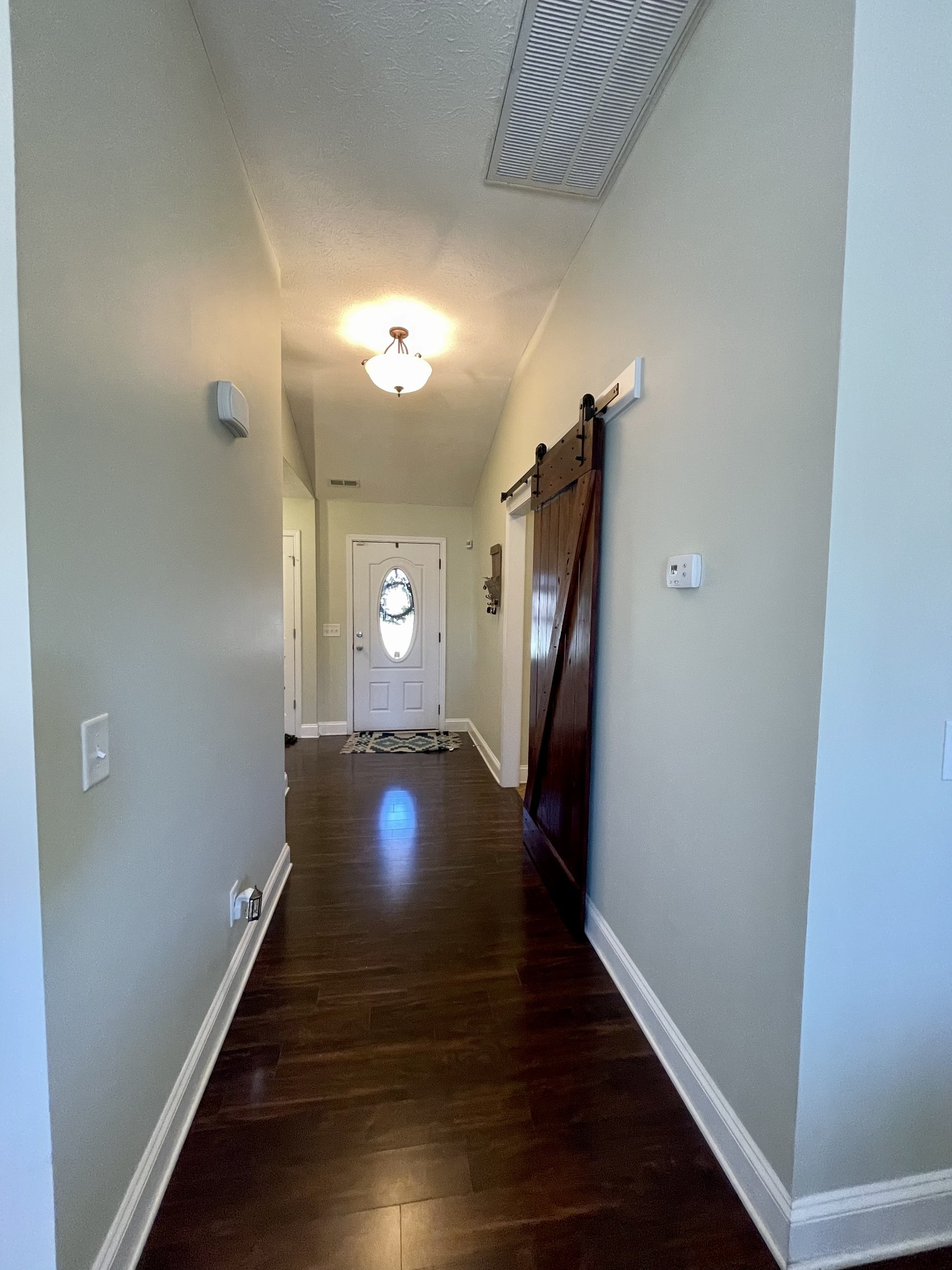 339 Golfview Lane Springfield, TN 37172 - Photo 19 of 34 a view of a hallway with wooden floor and stairs