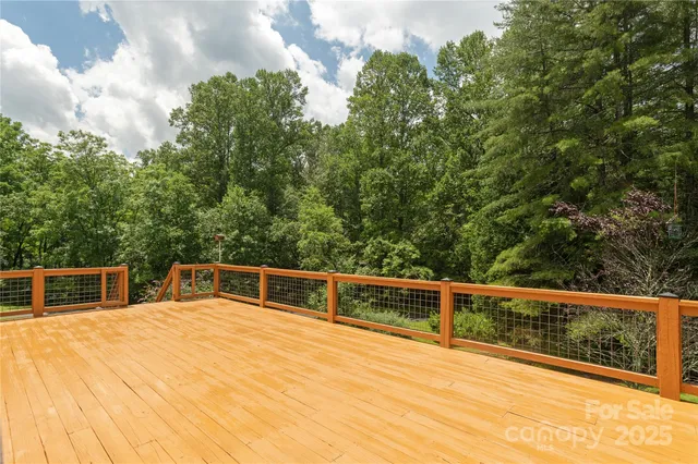 a view of a patio with couches table and chairs with wooden fence