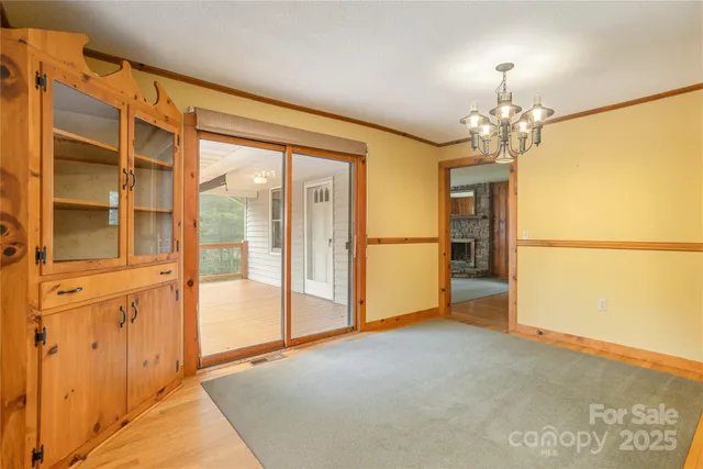 a view of a big room with wooden floor and windows