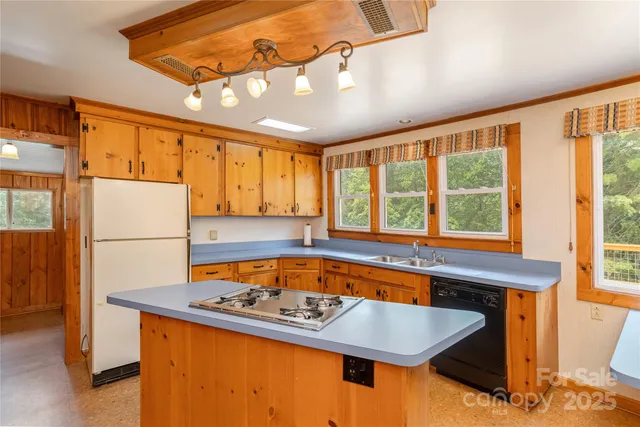 a kitchen with a refrigerator a sink and a stove