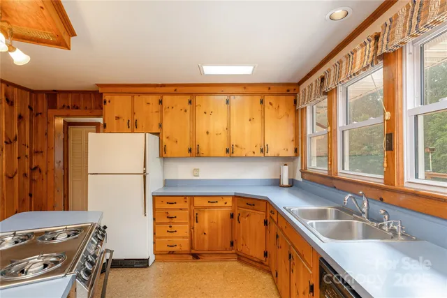 a view of a large kitchen with a sink and cabinets