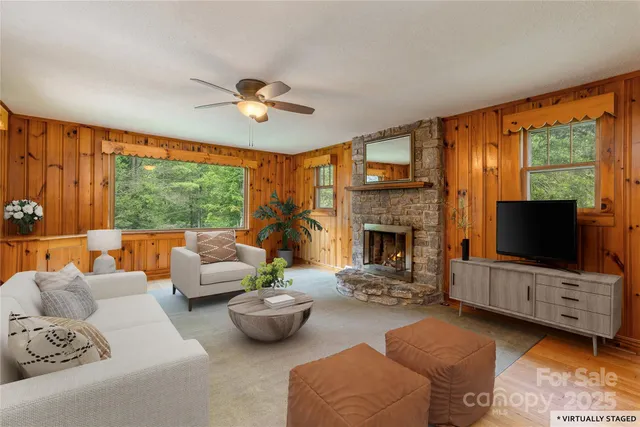 a living room with furniture flat screen tv and a fireplace