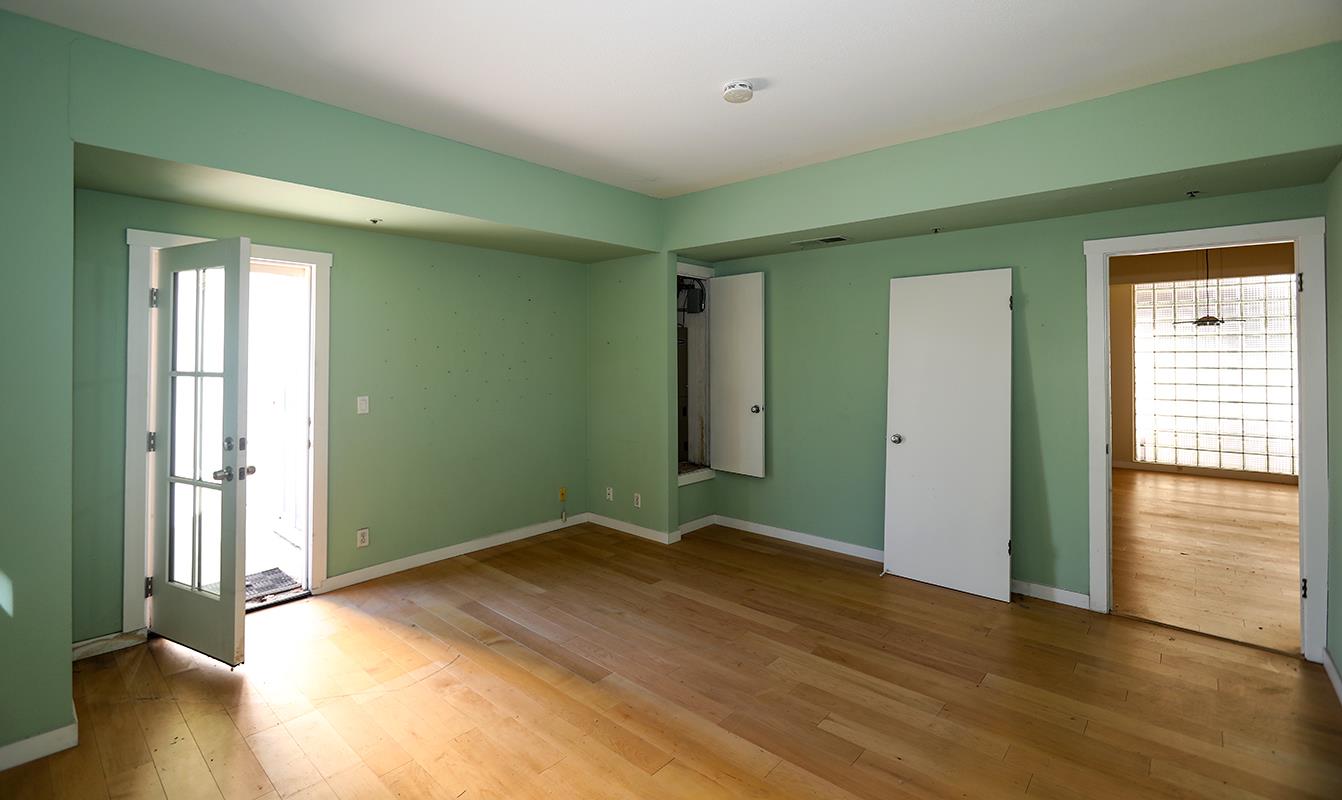 97 East St James Street, Unit 21 San Jose, CA 95112 - Photo 5 of 22 an empty room with wooden floor and windows