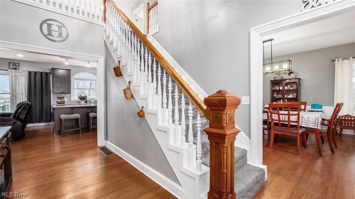 2531 Nicholas Lane Dresden, OH 43821 - Photo 18 of 40 Stairway with hardwood / wood-style floors and a chandelier