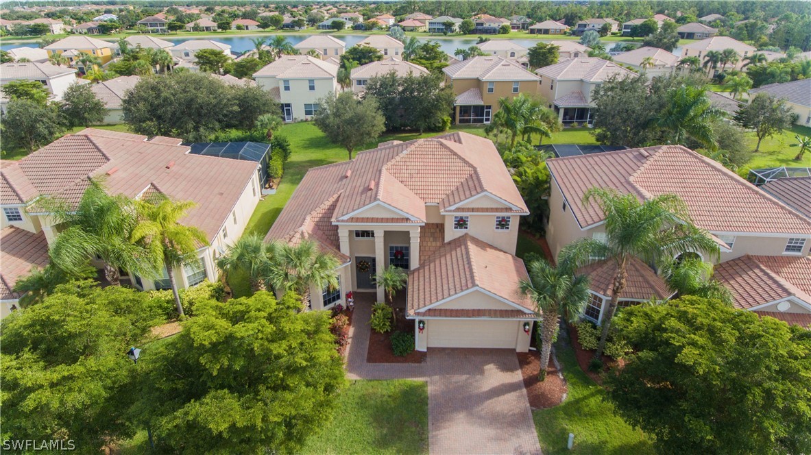 an aerial view of multiple houses with yard