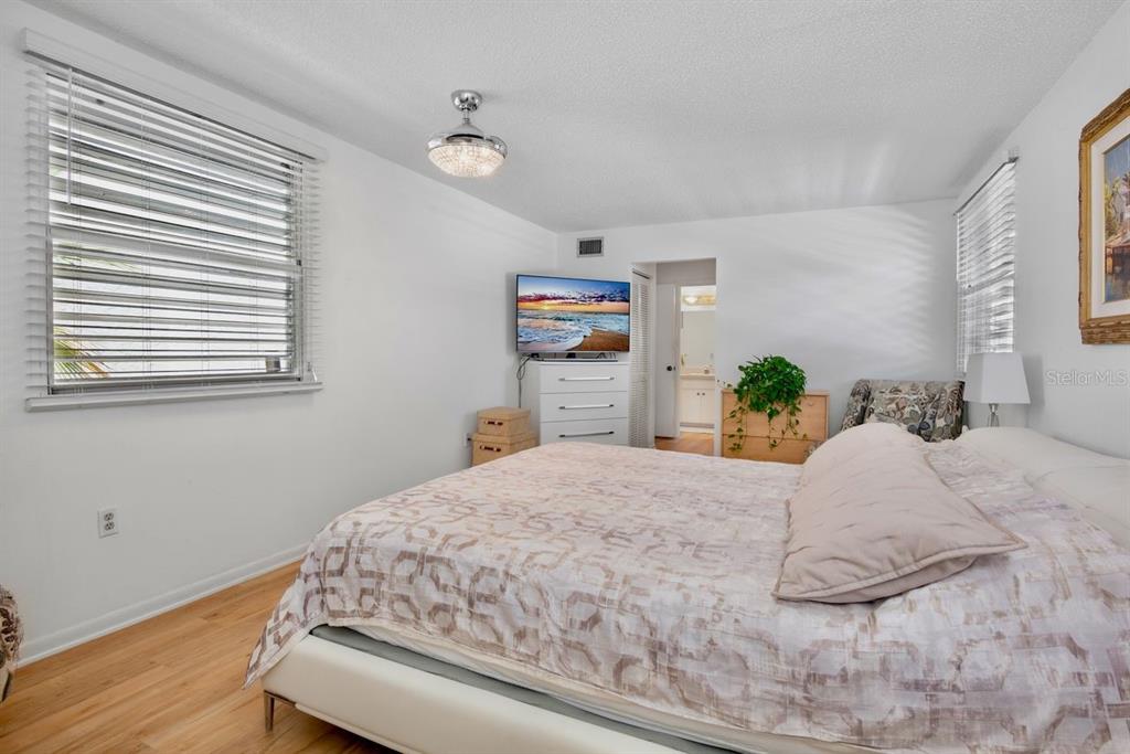5150 Marsh Field Lane, Unit 120 Sarasota, FL 34235 - Photo 11 of 21 a bedroom with a bed and wooden floor