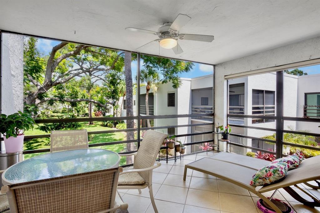 5150 Marsh Field Lane, Unit 120 Sarasota, FL 34235 - Photo 16 of 21 a room with lots of wooden furniture and a potted plant