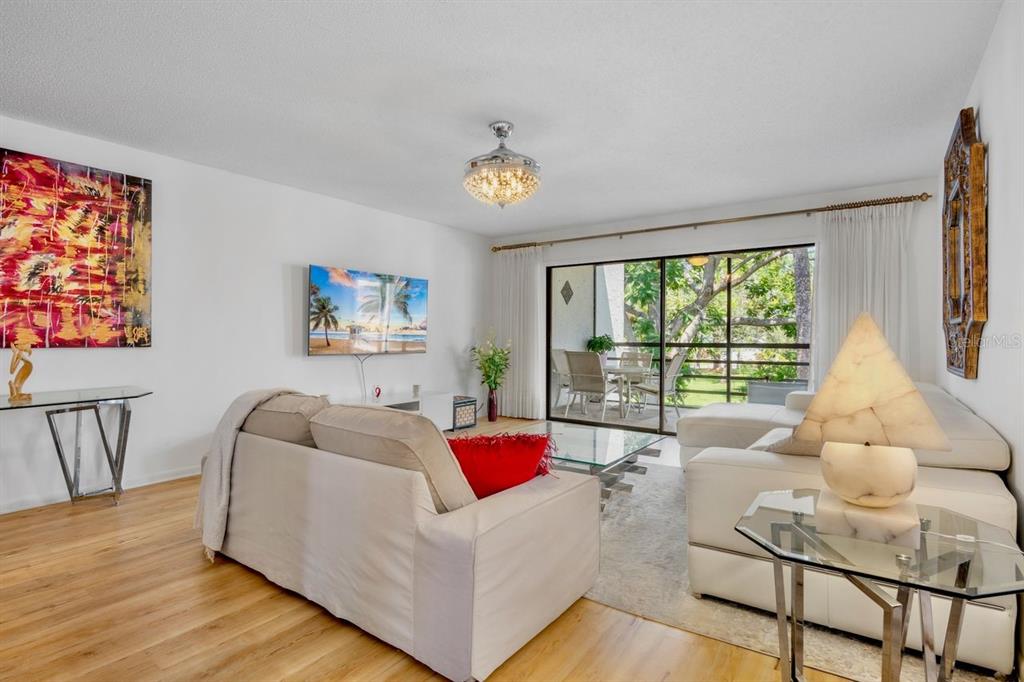 5150 Marsh Field Lane, Unit 120 Sarasota, FL 34235 - Photo 6 of 21 a living room with furniture and a large window