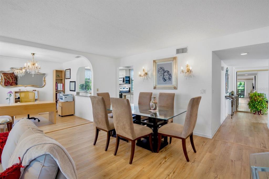 5150 Marsh Field Lane, Unit 120 Sarasota, FL 34235 - Photo 7 of 21 a view of a dining room with furniture and wooden floor