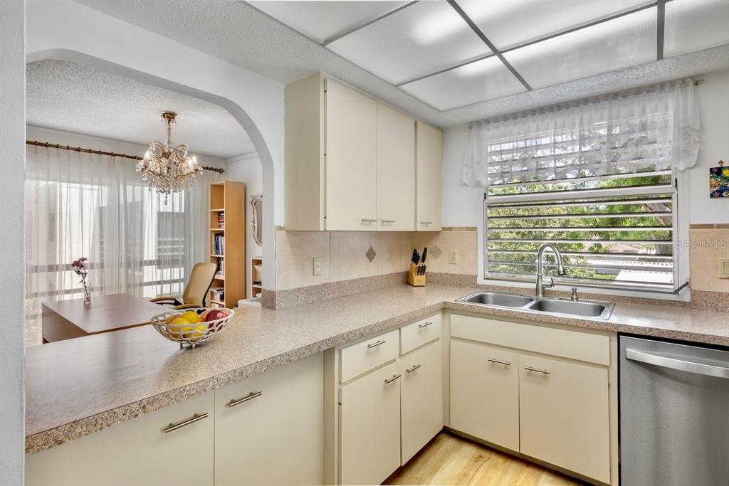 5150 Marsh Field Lane, Unit 120 Sarasota, FL 34235 - Photo 9 of 21 a kitchen with a sink and cabinets