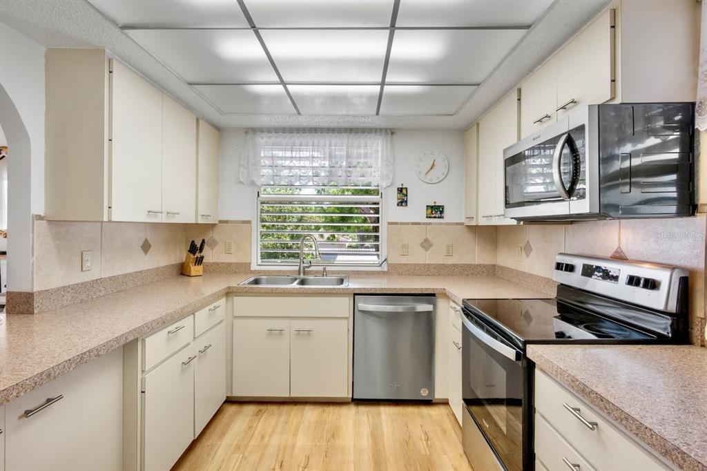 5150 Marsh Field Lane, Unit 120 Sarasota, FL 34235 - Photo 10 of 21 a kitchen with stainless steel appliances granite countertop a sink a stove and cabinets