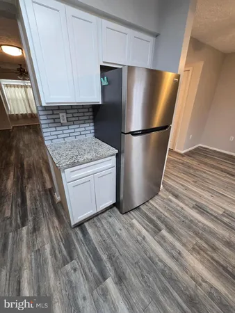 a kitchen with a refrigerator and a sink