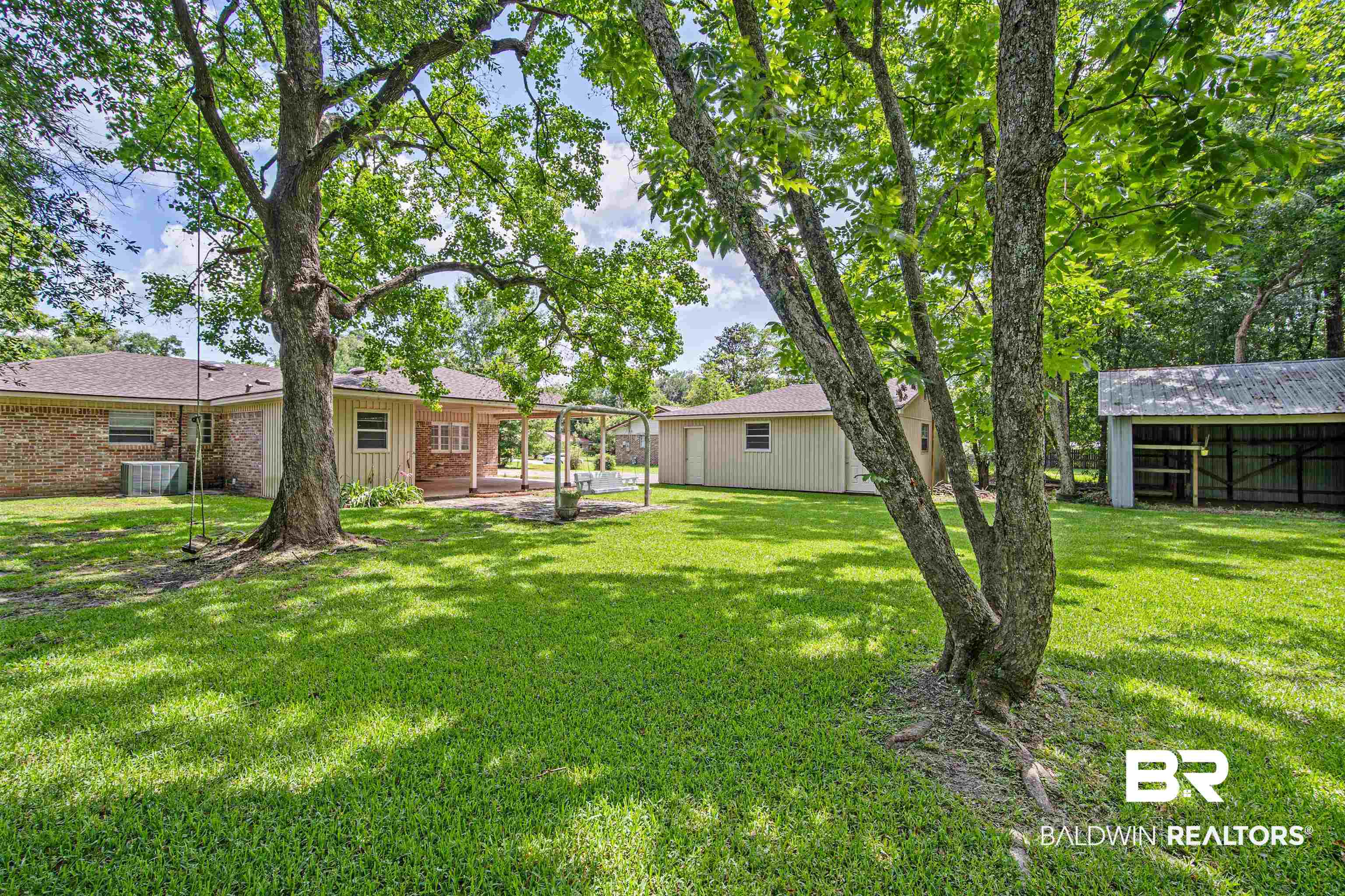 1325 Pawnee Circle Saraland, AL 36571 - Photo 25 of 26 View of grassy yard with a patio area
