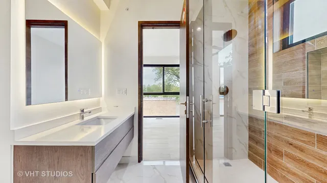 a view of a room with wooden floor and doors