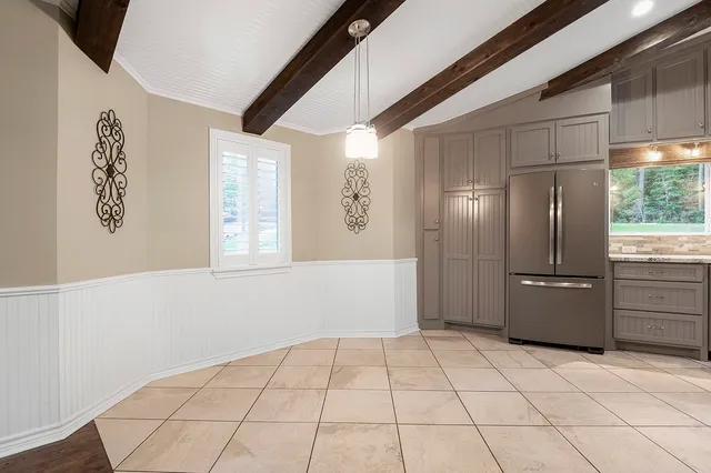 a kitchen with stainless steel appliances a refrigerator and a counter top space