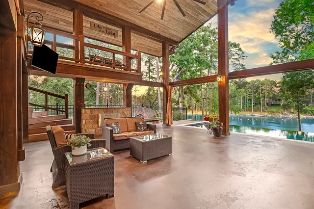 a living room with furniture and large windows