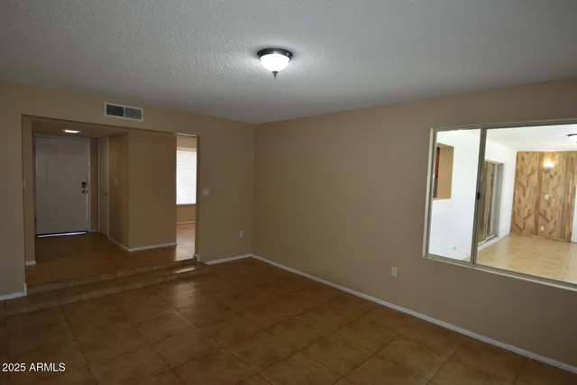 an empty room with windows and entrance