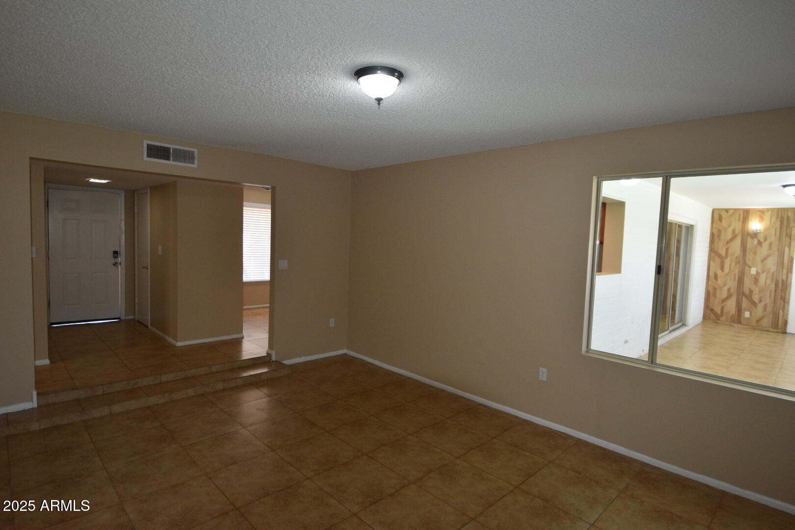 3720 West Purdue Avenue Phoenix, AZ 85051 - Photo 3 of 9 an empty room with windows and entrance