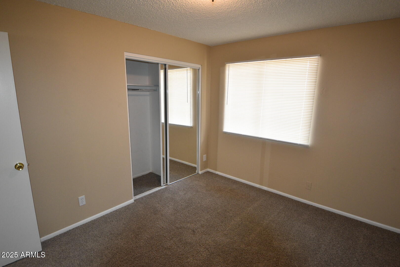 3720 West Purdue Avenue Phoenix, AZ 85051 - Photo 4 of 9 an empty room with windows