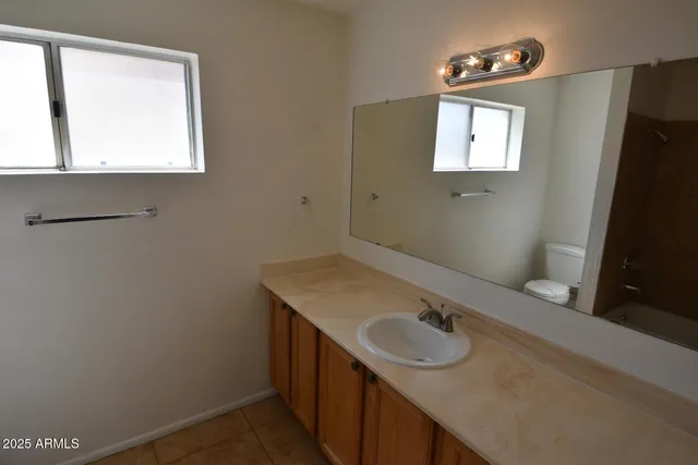 a bathroom with a sink a vanity and a mirror