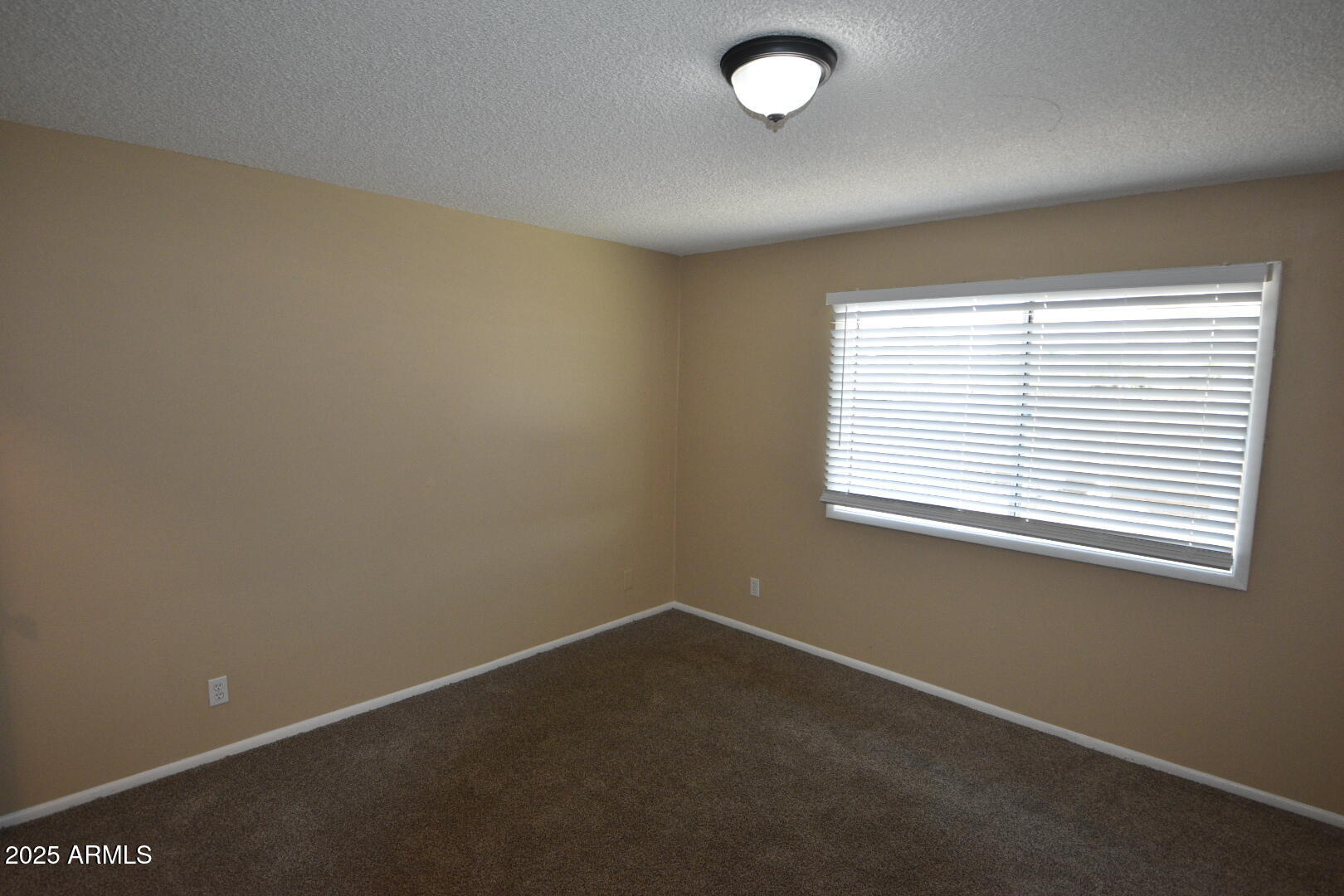 3720 West Purdue Avenue Phoenix, AZ 85051 - Photo 6 of 9 an empty room with a window